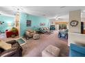 Bright living room featuring a teal accent wall and comfy furniture at 4195 Muirfield Loop, Lake Wales, FL 33859
