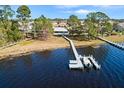 Lakefront home features a private boat dock, boat lift, and access to beautiful water views at 462 Sweetwater Way, Haines City, FL 33844