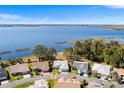 Aerial view of lakeside homes with private docks and large lake, showing surrounding greenery at 462 Sweetwater Way, Haines City, FL 33844