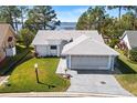 Single-story home with lake view and spacious driveway at 462 Sweetwater Way, Haines City, FL 33844