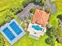 Aerial view of community amenities including tennis courts, pool, and clubhouse at 608 Sweet Bay Cir, Winter Haven, FL 33884