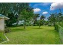Spacious backyard with mature trees, offering a private and serene outdoor space at 922 S Lake Reedy Blvd, Frostproof, FL 33843