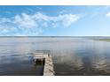 Scenic view of the private wooden dock on the tranquil lake, perfect for relaxation and enjoying water activities at 922 S Lake Reedy Blvd, Frostproof, FL 33843