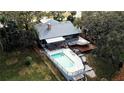 Aerial view shows home with pool, deck, and private dock access at 952 N Heron Cir, Winter Haven, FL 33884