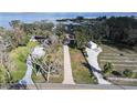 Sprawling estate features long driveway leading to main house with lake access and several outbuildings at 1006 W Lake Hamilton Dr, Winter Haven, FL 33881