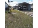 Metal carport for RV and car parking with grass yard at 1027 Bradbury Rd, Winter Haven, FL 33880