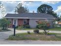 Charming single-story home with a well-maintained lawn and circular driveway at 108 Prospect Ave, Winter Haven, FL 33880