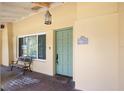 Inviting front porch with a decorative door, charming bench, and address number at 1121 Sunset Dr, Lake Wales, FL 33853