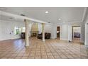 Bright living room featuring a fireplace and access to kitchen and dining areas at 1121 Sunset Dr, Lake Wales, FL 33853