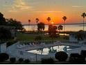 Community pool with lake view at sunset at 1600 W Lake Parker Dr # C25, Lakeland, FL 33805