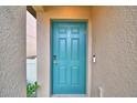 Teal front door with keyless entry and doorbell camera at 1713 Yellow Trl, Lakeland, FL 33801