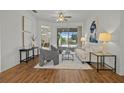 Bright living room with hardwood floors, comfy seating, and a view of the pool at 176 Brookshire Dr, Lake Wales, FL 33898