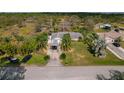 Aerial view of a house and surrounding property with a pond nearby at 208 Limpkin Ln, Frostproof, FL 33843