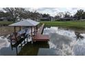 Private wooden dock with covered boat lift at 2400 Crump Rd, Winter Haven, FL 33881