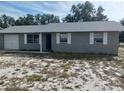 Newly painted gray brick ranch home with a spacious yard and attached garage at 2790 Avenue L Nw, Winter Haven, FL 33881