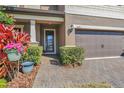 Inviting front entrance with brick walkway and lush landscaping at 2821 Mead Ave, St Cloud, FL 34771