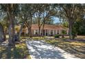 Beautiful single-story brick home with a long driveway and mature landscaping at 3746 Red Oak Ct, Lake Wales, FL 33898