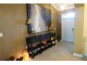 Inviting foyer with a console table, stylish decor, tiled floor, and front door at 3926 Bedford Ave, Winter Haven, FL 33884