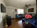 Living room with teal couches, wood floors, and a ceiling fan at 4089 Lana Dr, Lakeland, FL 33813