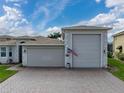 Exterior view of a house featuring a large garage and driveway at 4240 Dunmore Dr, Lake Wales, FL 33859