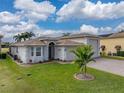 House exterior showcasing a two-car garage and landscaping at 4240 Dunmore Dr, Lake Wales, FL 33859