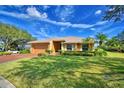 Single-story house with a large front yard and palm trees at 514 Lake Mariam Ter, Winter Haven, FL 33884