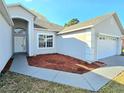 Beautiful single-story home with attached two-car garage, manicured landscaping, and freshly laid mulch at 746 Platypus Ct, Kissimmee, FL 34759