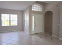 Open-concept living area featuring neutral paint, tile flooring, and lots of natural light at 746 Platypus Ct, Kissimmee, FL 34759