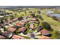 Aerial view of home with mature trees, landscaping and near a golf course at 768 Canberra Rd, Winter Haven, FL 33884