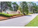 Cypresswood Golf & Country Club entrance with lush landscaping and well-maintained signage at 768 Canberra Rd, Winter Haven, FL 33884