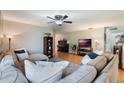 Comfortable living room with hardwood floors, ceiling fan and lots of seating at 768 Canberra Rd, Winter Haven, FL 33884
