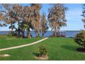 Landscaped backyard with lake access and private dock at 8323 W Lake Marion Rd, Haines City, FL 33844