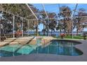 Relaxing screened-in pool area with lake view at 8323 W Lake Marion Rd, Haines City, FL 33844
