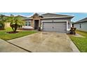 Curb appeal abounds in this one-story home with a gray exterior at 918 Revere Ave, Haines City, FL 33844