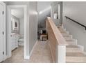 Inviting foyer with staircase, neutral tile flooring, and half-bath access at 1 Casarena Ct, Winter Haven, FL 33881