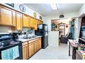 Functional kitchen featuring wood cabinets and essential appliances for everyday cooking at 115 Jefferson St, Lake Wales, FL 33859