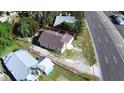 Aerial view of a home with a brown roof, surrounded by a well-defined property line and nearby street at 1155 S Lake Shore Way, Lake Alfred, FL 33850