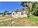 Charming single-Gathering home with a white front door, small porch, and lush greenery at 1155 S Lake Shore Way, Lake Alfred, FL 33850