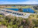 Aerial view of townhomes near a pond, golf course, and lush green landscape at 1157 Blue Jay Dr, Davenport, FL 33837