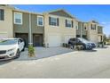 Exterior view of several townhomes, each featuring a garage and a neutral color scheme at 1157 Blue Jay Dr, Davenport, FL 33837