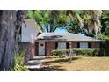 Close up front elevation of brick home with a manicured yard at 148 Lake Otis Rd, Winter Haven, FL 33884