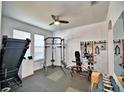 A dedicated home gym, including free weights, a weight machine, a treadmill, and rubber flooring at 1510 Shorewood Dr, Auburndale, FL 33823