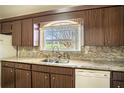 Kitchen featuring wood cabinets, granite countertops, and a window view at 1815 Adams Barn Rd, Lake Alfred, FL 33850
