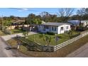 Charming single-story home with a metal roof, a fenced yard, and well-maintained landscaping at 1817 Mckeown Ave, Haines City, FL 33844