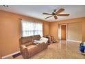 Relaxing living room featuring a cozy sofa and tile flooring at 20 24Th Sw St, Winter Haven, FL 33880