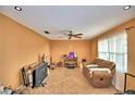 Open living room with tile flooring, ceiling fan, and abundant natural light at 20 24Th Sw St, Winter Haven, FL 33880