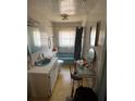 Retro bathroom featuring a blue tub and sink with vintage fixtures at 216 Dorsett Ave, Lake Wales, FL 33853