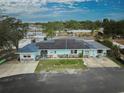 A view from above of a single-story home featuring solar panels, a bright exterior and the community docks at 253 Blackwell Villa Cv, Babson Park, FL 33827