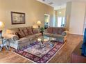 Comfortable living room featuring plush sofas, patterned rug, and ample natural light at 295 Lake Suzanne Dr, Lake Wales, FL 33859