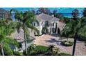 Beautiful home boasting water views, a circular driveway, and a meticulously manicured lawn at 3312 Eagles Trce, Winter Haven, FL 33884